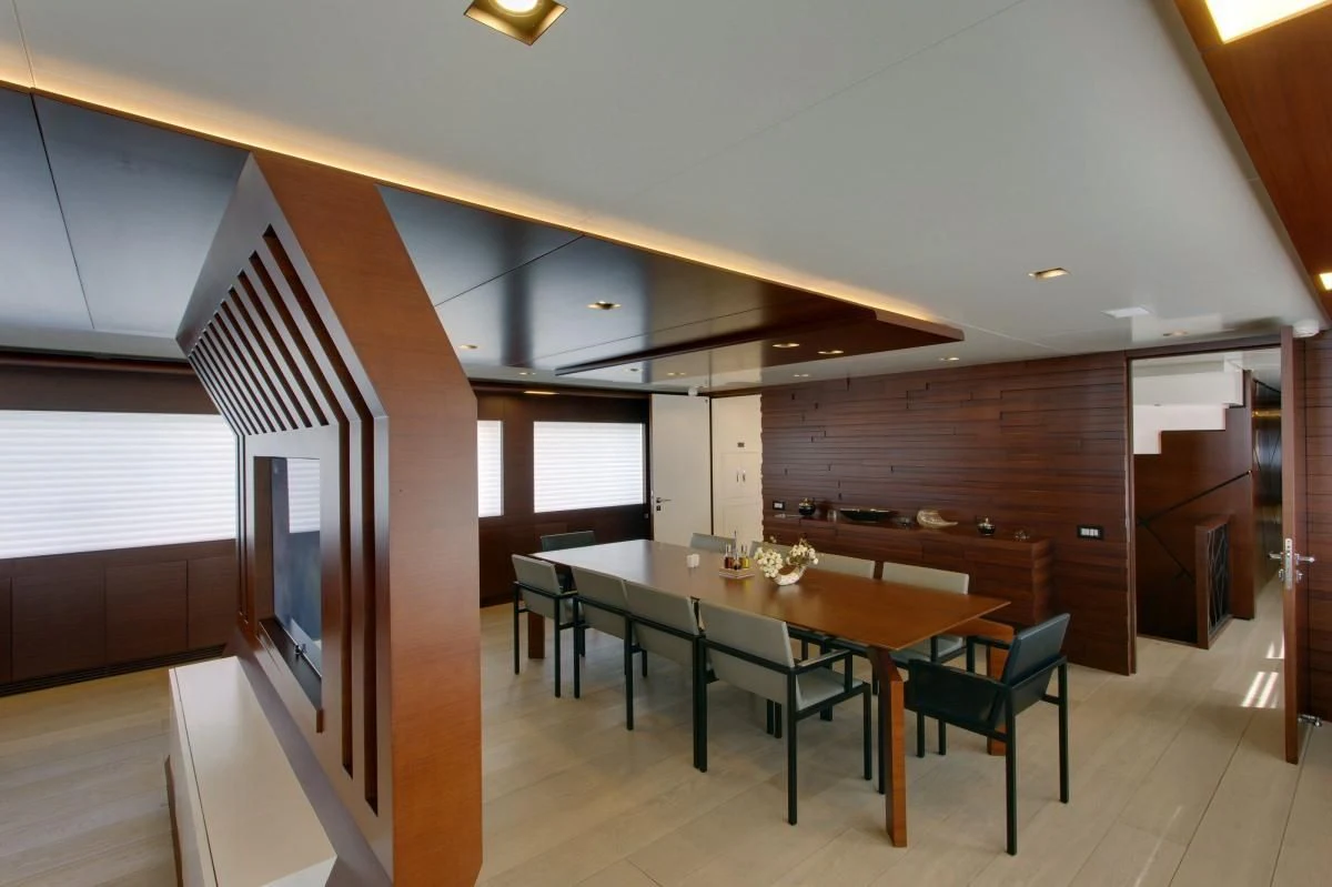 a room with a table and chairs aboard BEBE Yacht for Sale