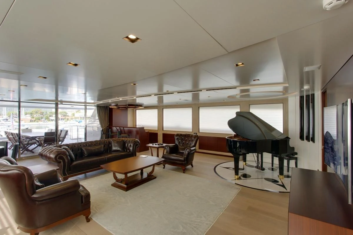 a living room with a piano aboard BEBE Yacht for Sale