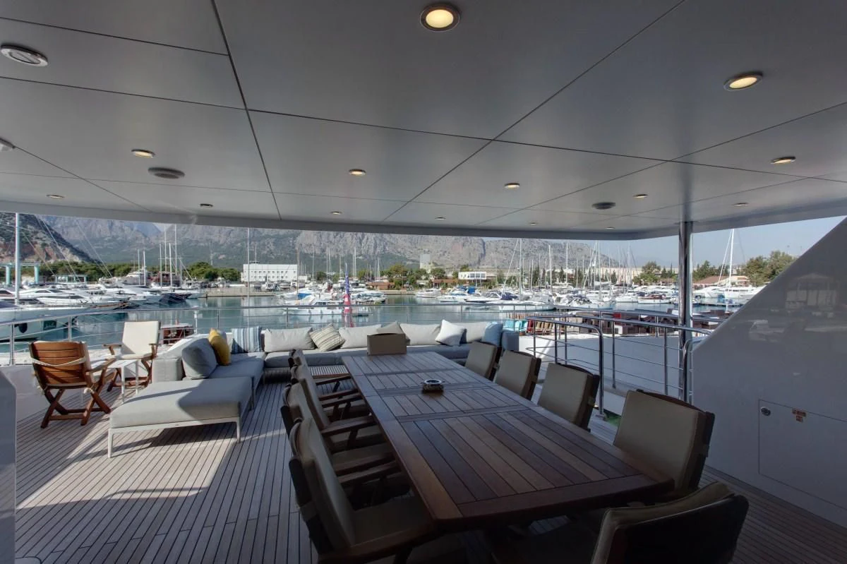 a table with chairs on it aboard BEBE Yacht for Sale