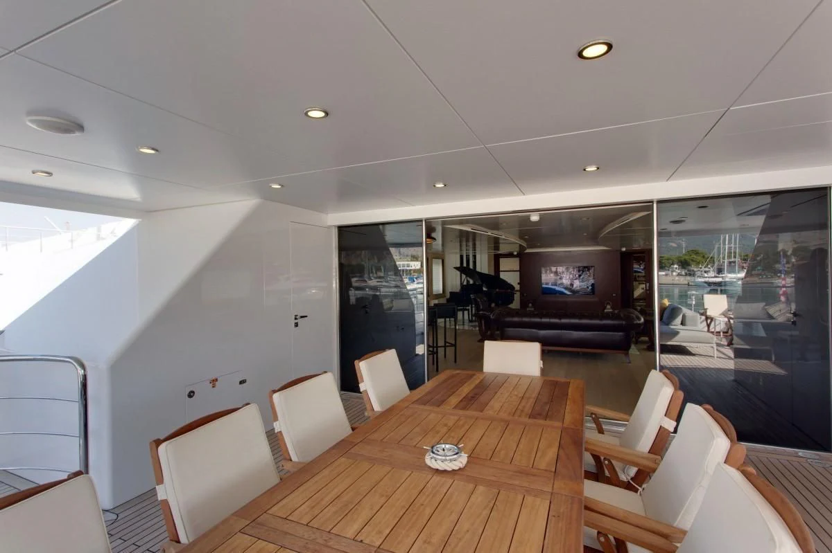 a room with a table and chairs aboard BEBE Yacht for Sale