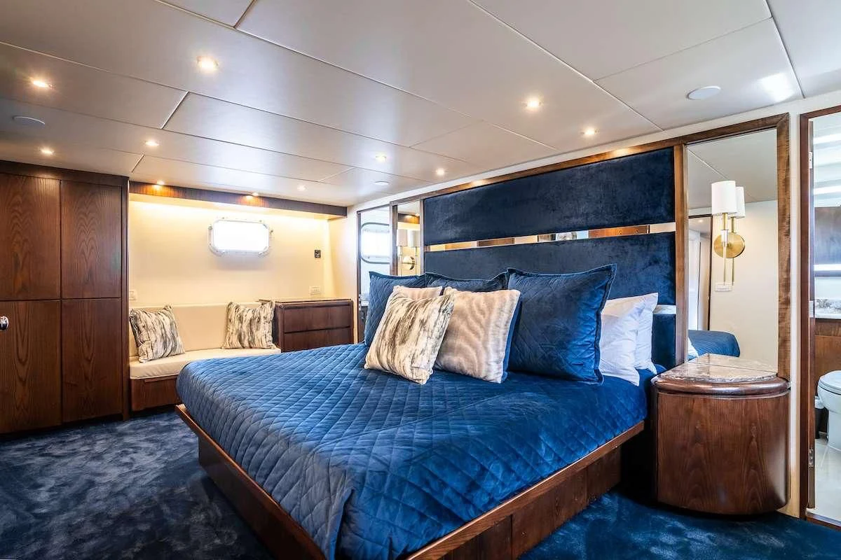 a bedroom with a bed and a desk aboard A PLACE IN THE SUN Yacht for Sale