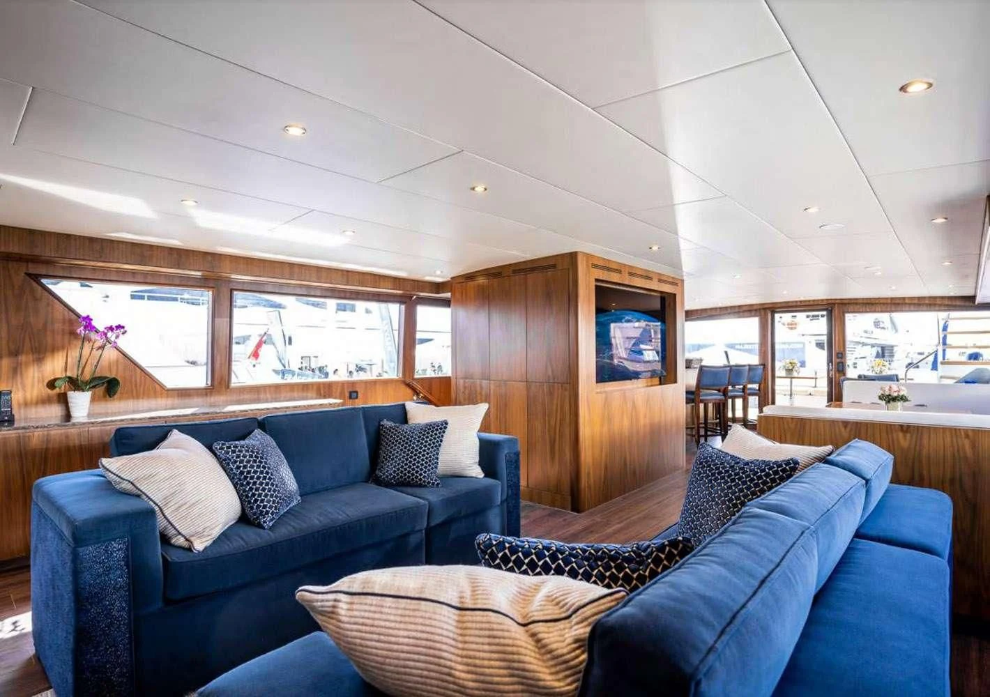 a living room with a blue couch aboard A PLACE IN THE SUN Yacht for Sale