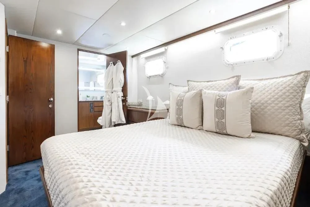 a bed with white sheets aboard A PLACE IN THE SUN Yacht for Sale