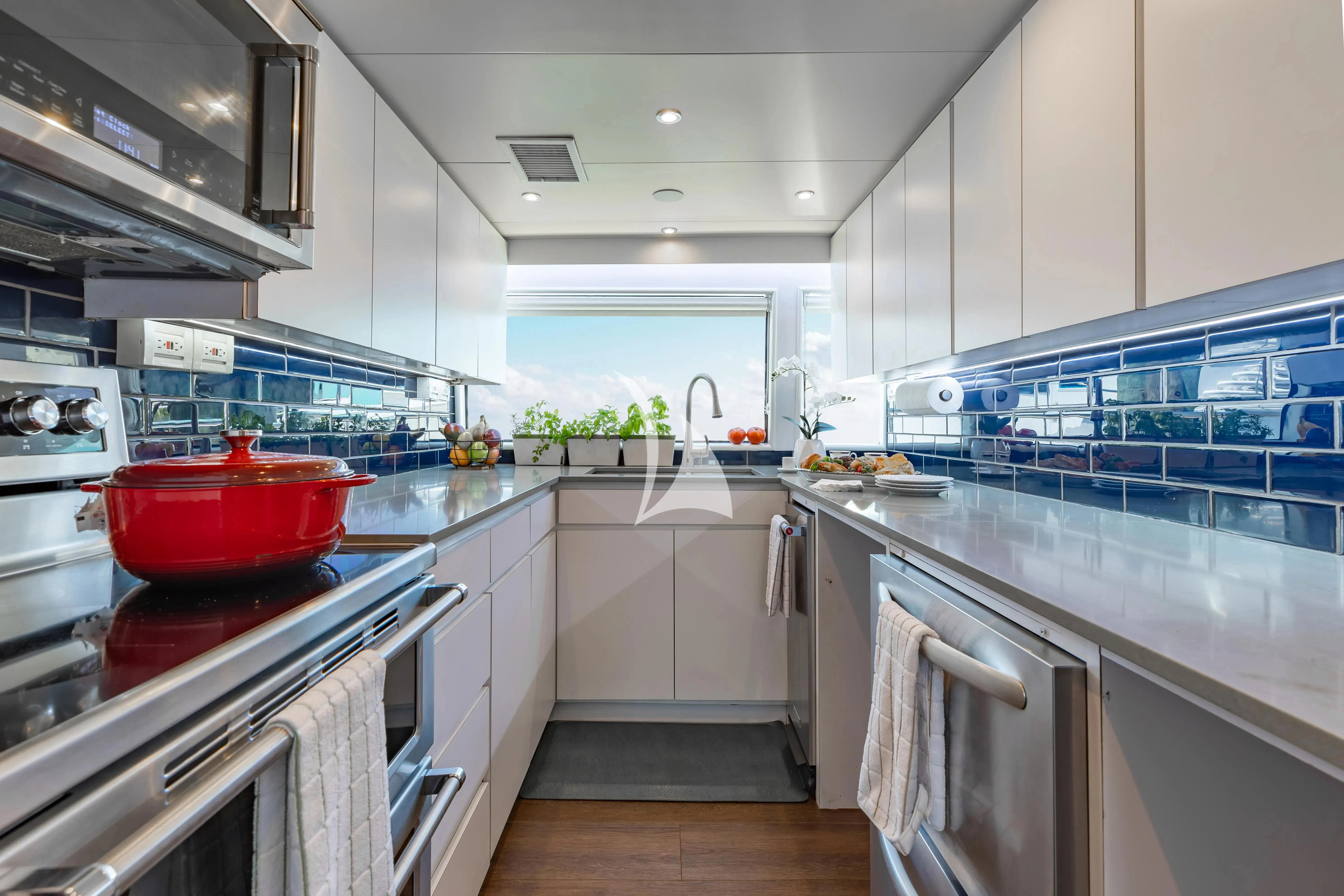 a kitchen with a large island aboard A PLACE IN THE SUN Yacht for Sale