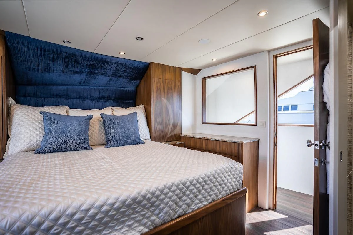 a bed with blue sheets aboard A PLACE IN THE SUN Yacht for Sale
