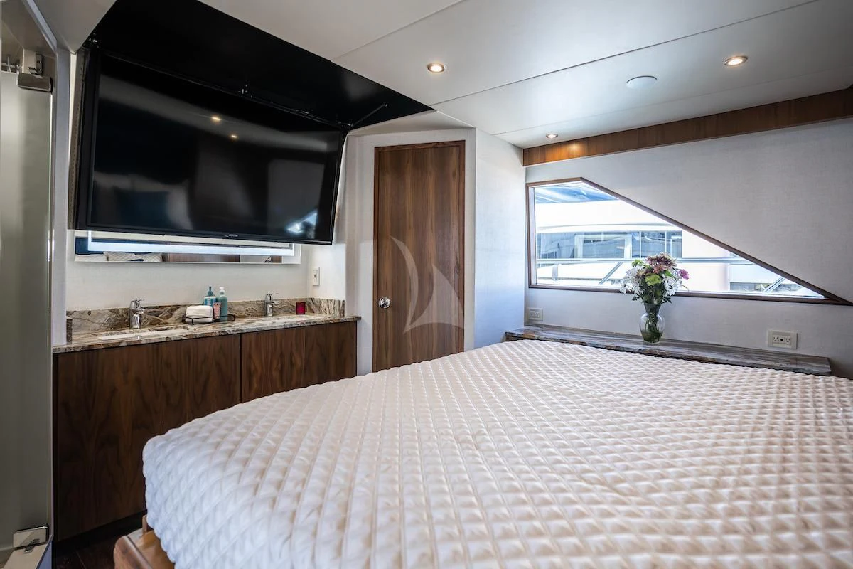 a large bedroom with a large bed aboard A PLACE IN THE SUN Yacht for Sale