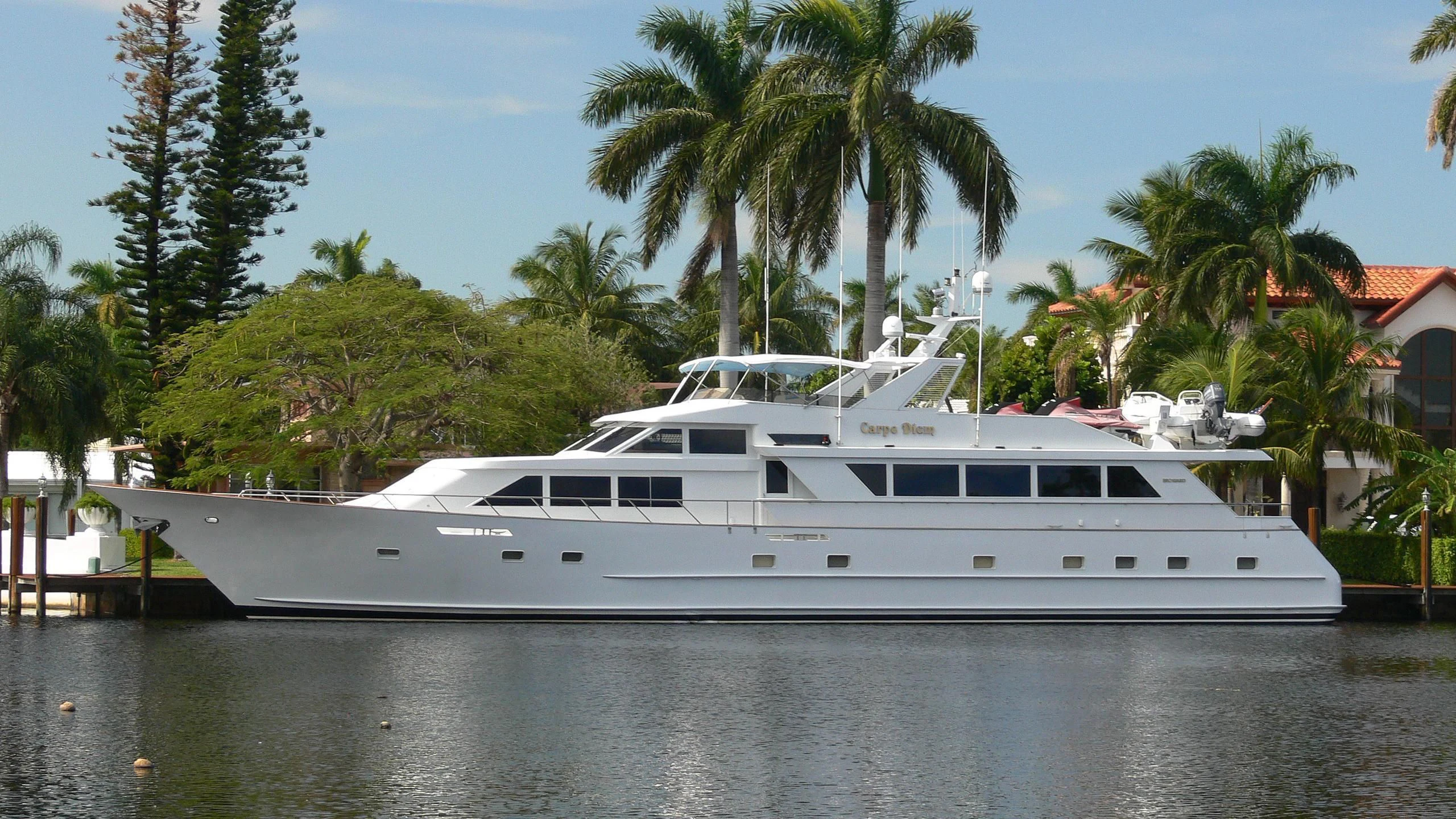 a white yacht on a lake aboard A PLACE IN THE SUN Yacht for Sale