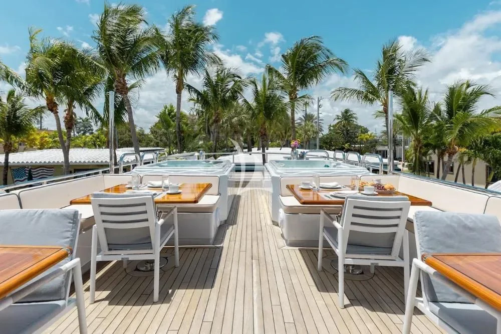 a patio with tables and chairs aboard A PLACE IN THE SUN Yacht for Sale