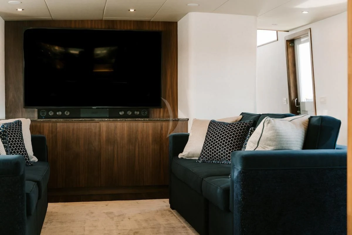 a living room with a couch and a tv aboard A PLACE IN THE SUN Yacht for Sale
