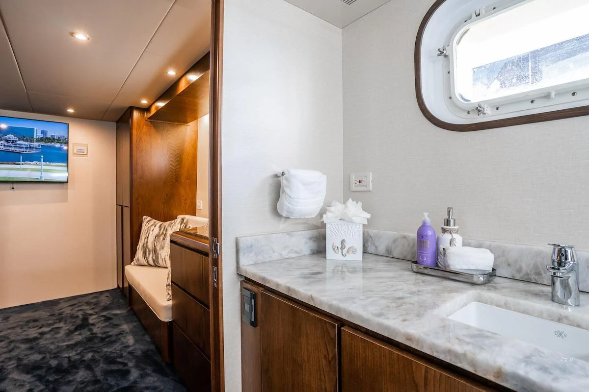 a bathroom with a sink and a mirror aboard A PLACE IN THE SUN Yacht for Sale