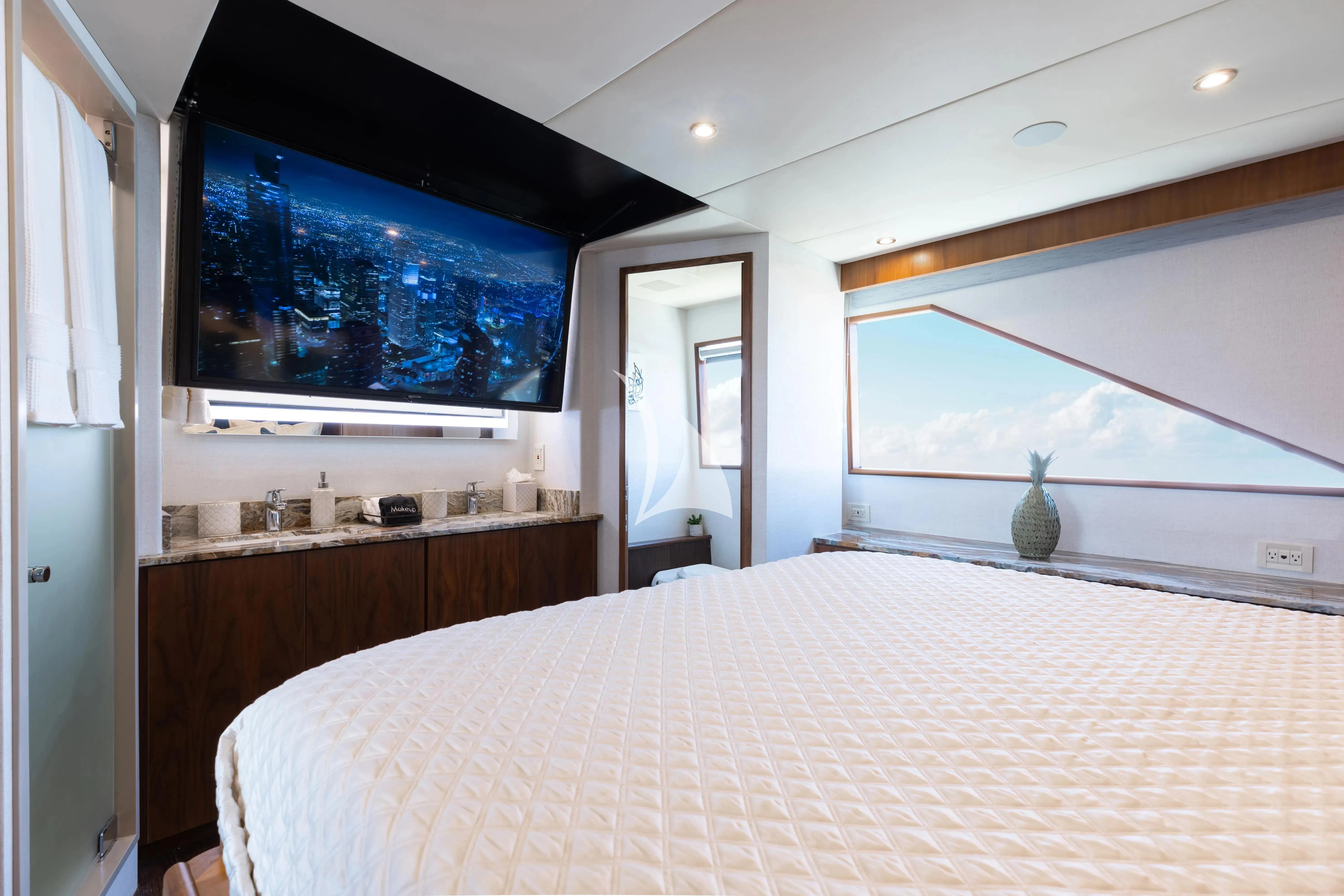 a bedroom with a large television aboard A PLACE IN THE SUN Yacht for Sale
