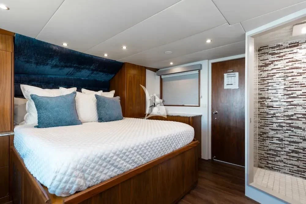 a bedroom with a bed and a window aboard A PLACE IN THE SUN Yacht for Sale