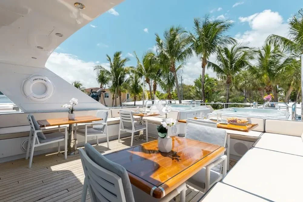 a table and chairs on a patio aboard A PLACE IN THE SUN Yacht for Sale