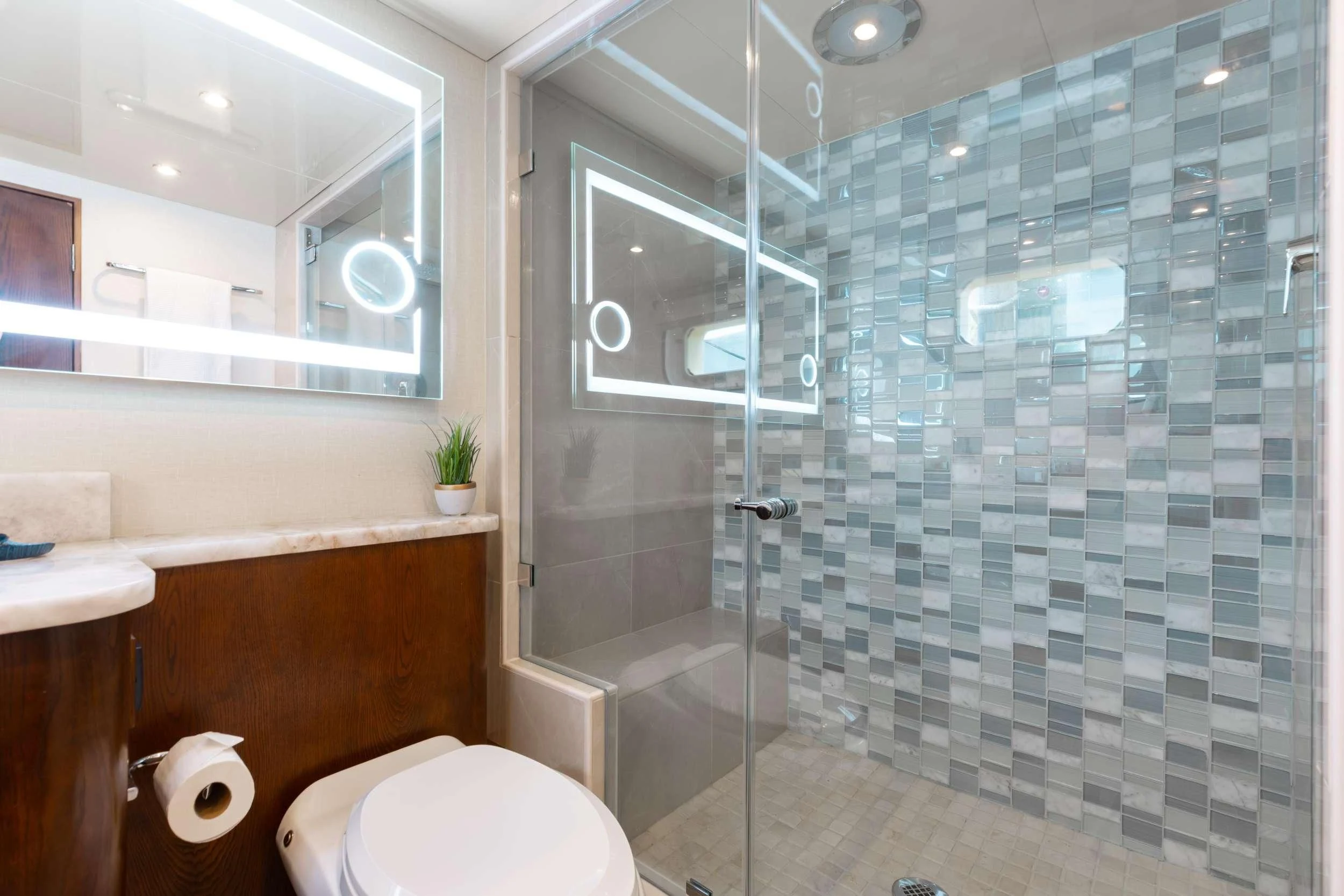 a bathroom with a glass shower aboard A PLACE IN THE SUN Yacht for Sale