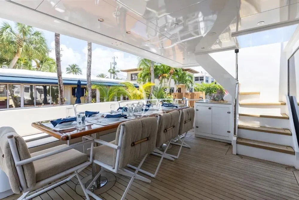 a dining room with a table and chairs aboard A PLACE IN THE SUN Yacht for Sale