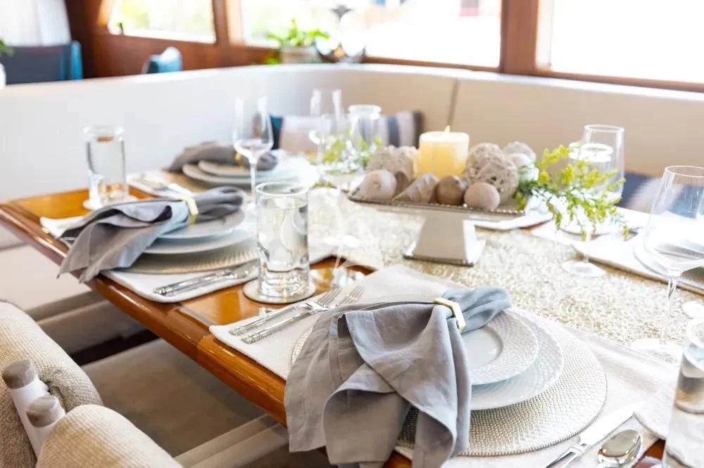 a table with place settings aboard A PLACE IN THE SUN Yacht for Sale