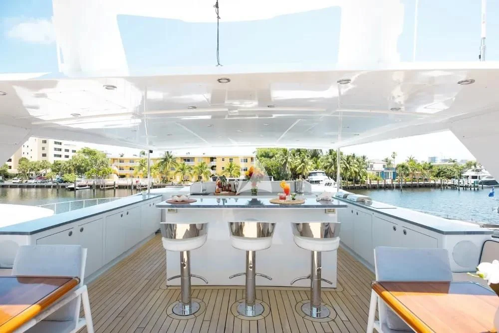 a large white building with a pool and tables aboard A PLACE IN THE SUN Yacht for Sale