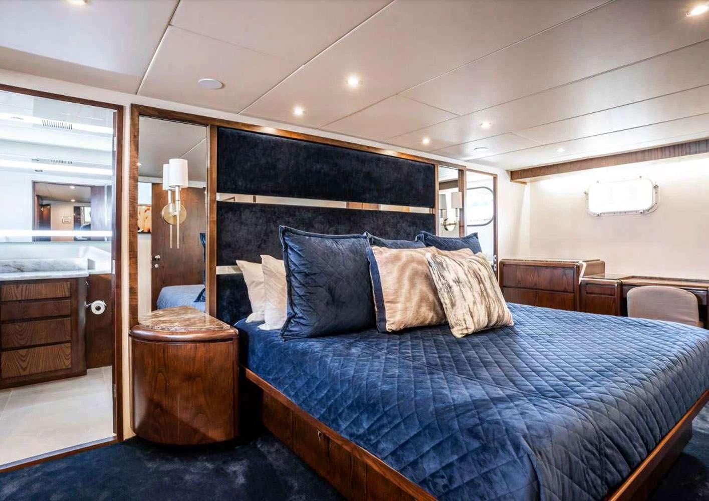 a bed with a blue comforter aboard A PLACE IN THE SUN Yacht for Sale