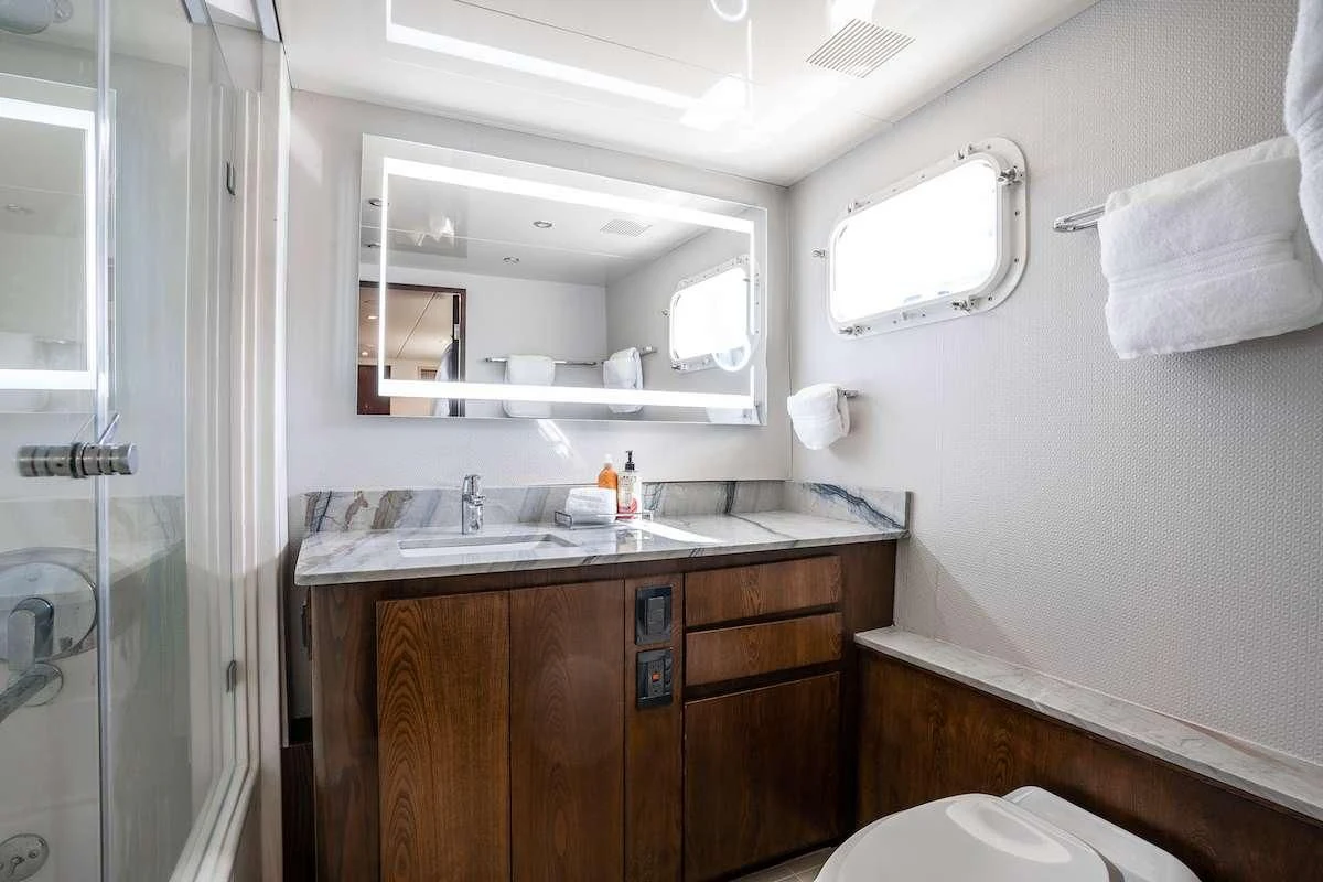 a bathroom with a sink and a mirror aboard A PLACE IN THE SUN Yacht for Sale