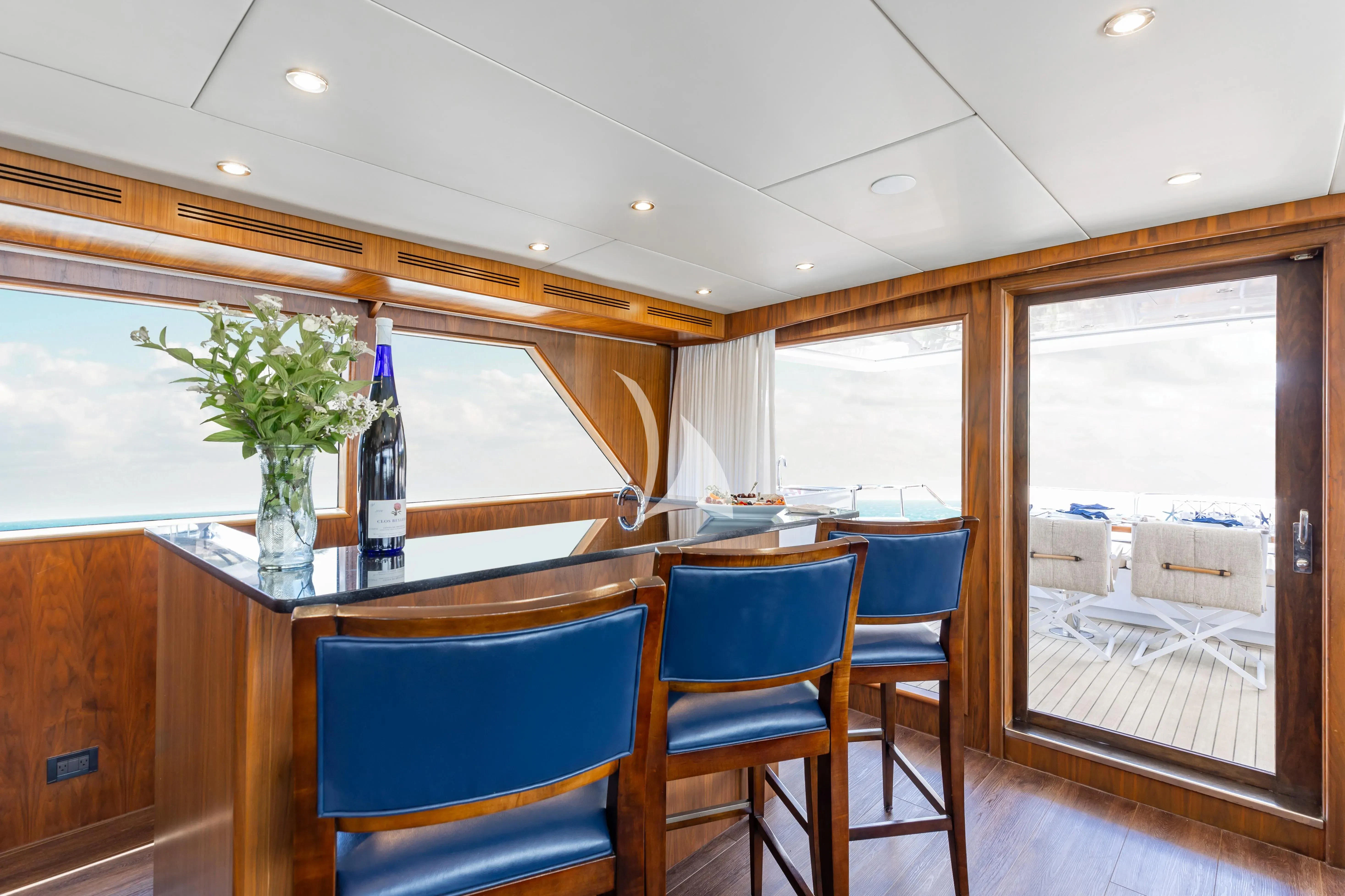 a glass table with a vase of flowers on it aboard A PLACE IN THE SUN Yacht for Sale