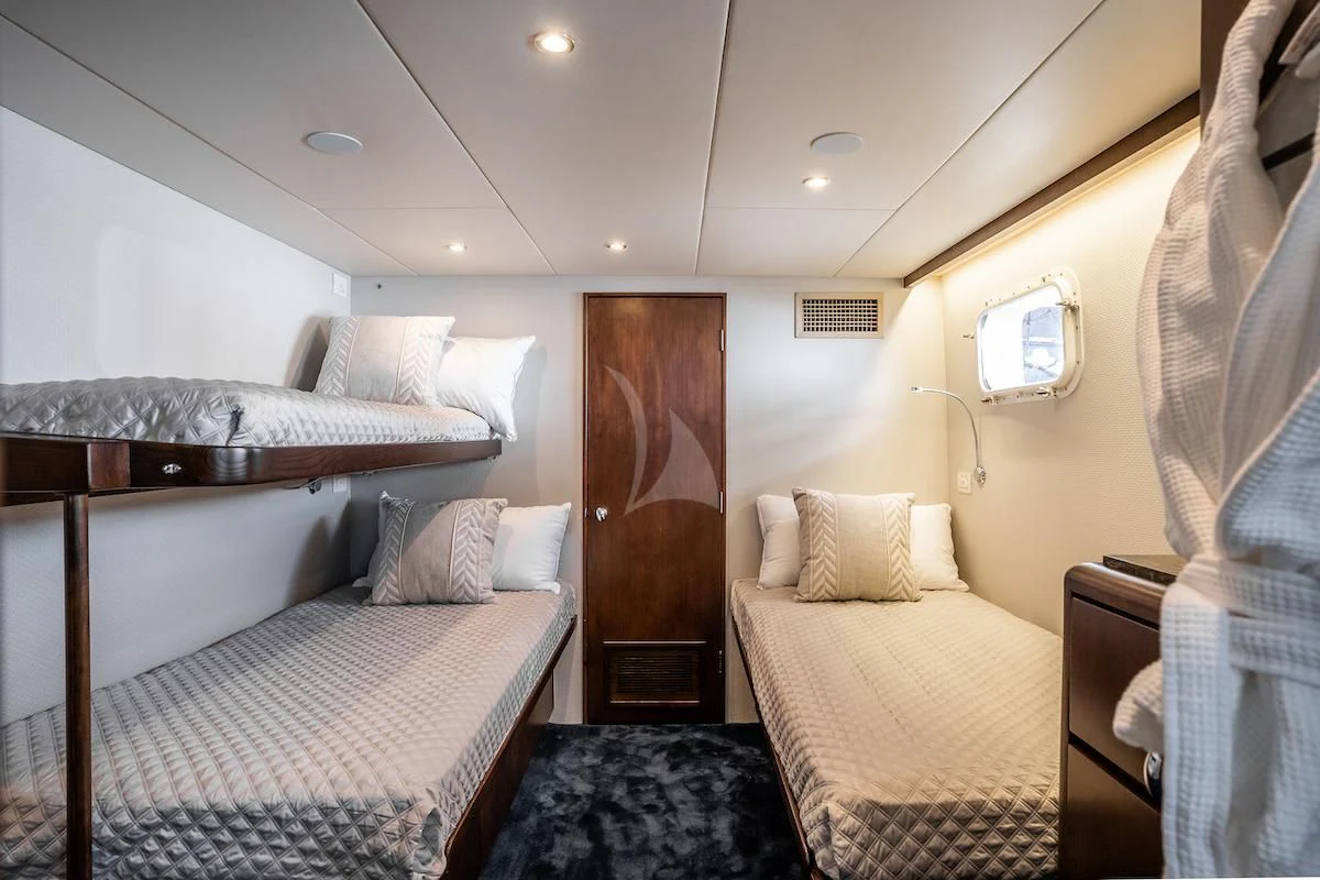 a couple of beds in a hotel room aboard A PLACE IN THE SUN Yacht for Sale