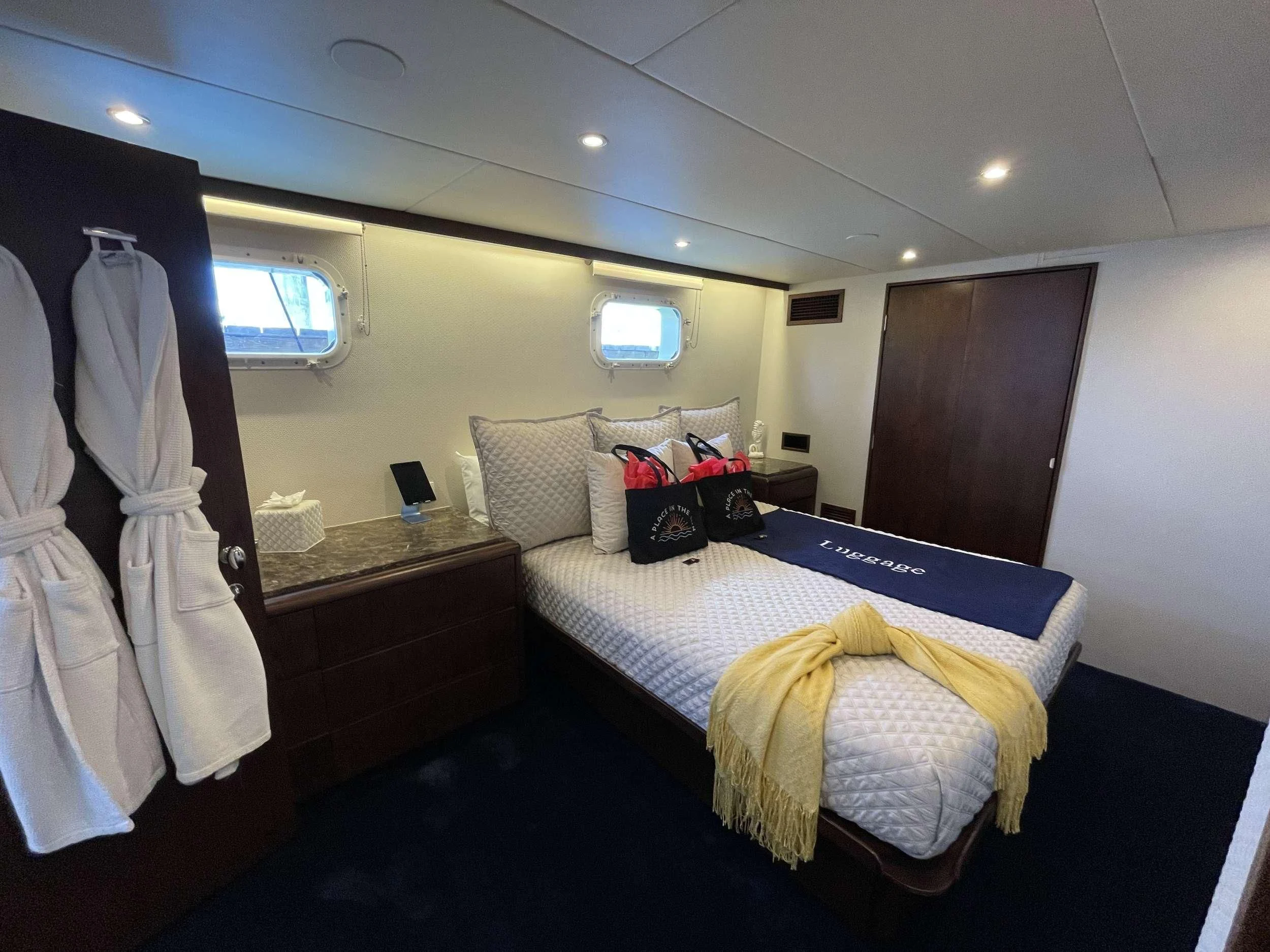 a bedroom with a bed and a desk aboard A PLACE IN THE SUN Yacht for Sale