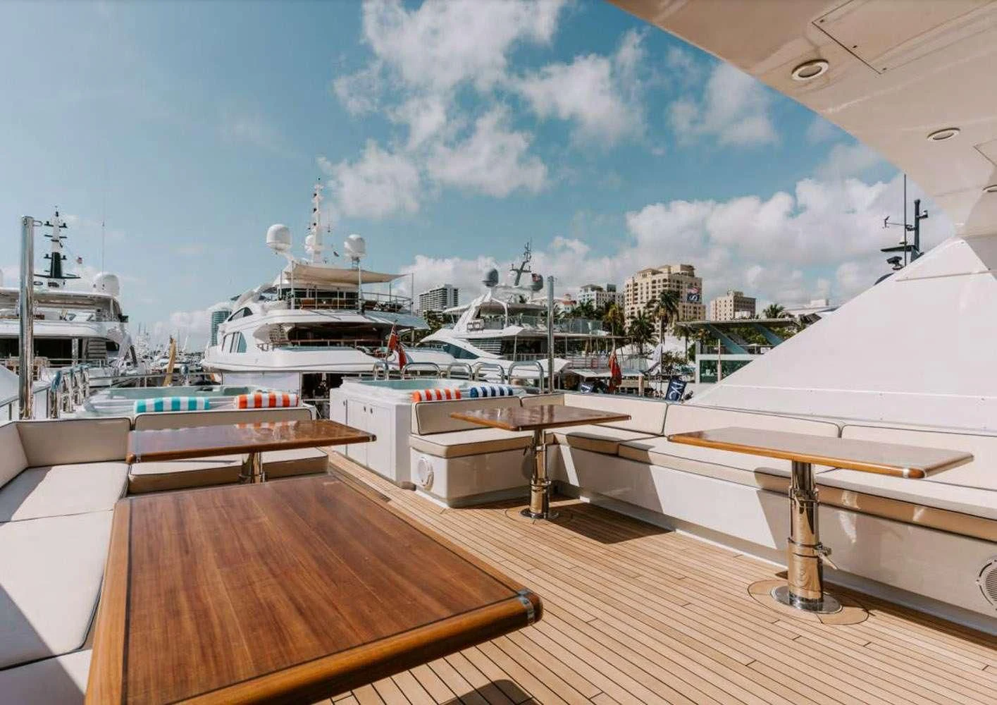 a deck with a deck and a view of a city aboard A PLACE IN THE SUN Yacht for Sale