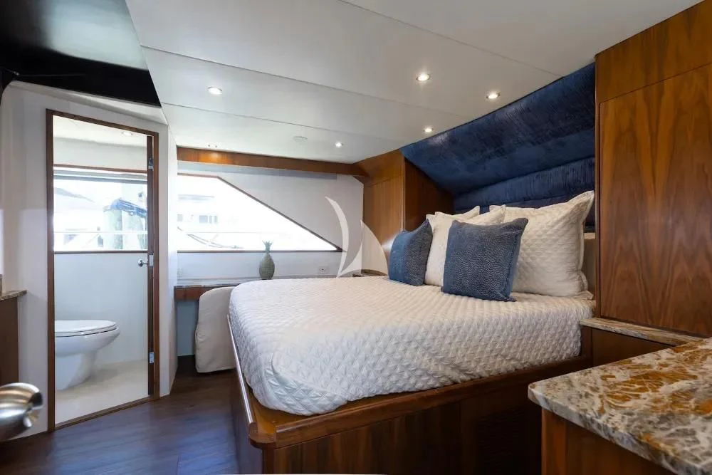 a bedroom with a bed and a sink aboard A PLACE IN THE SUN Yacht for Sale
