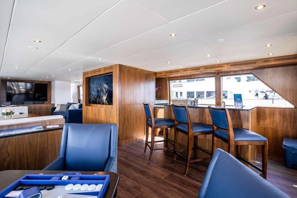 a room with chairs and a table aboard A PLACE IN THE SUN Yacht for Sale