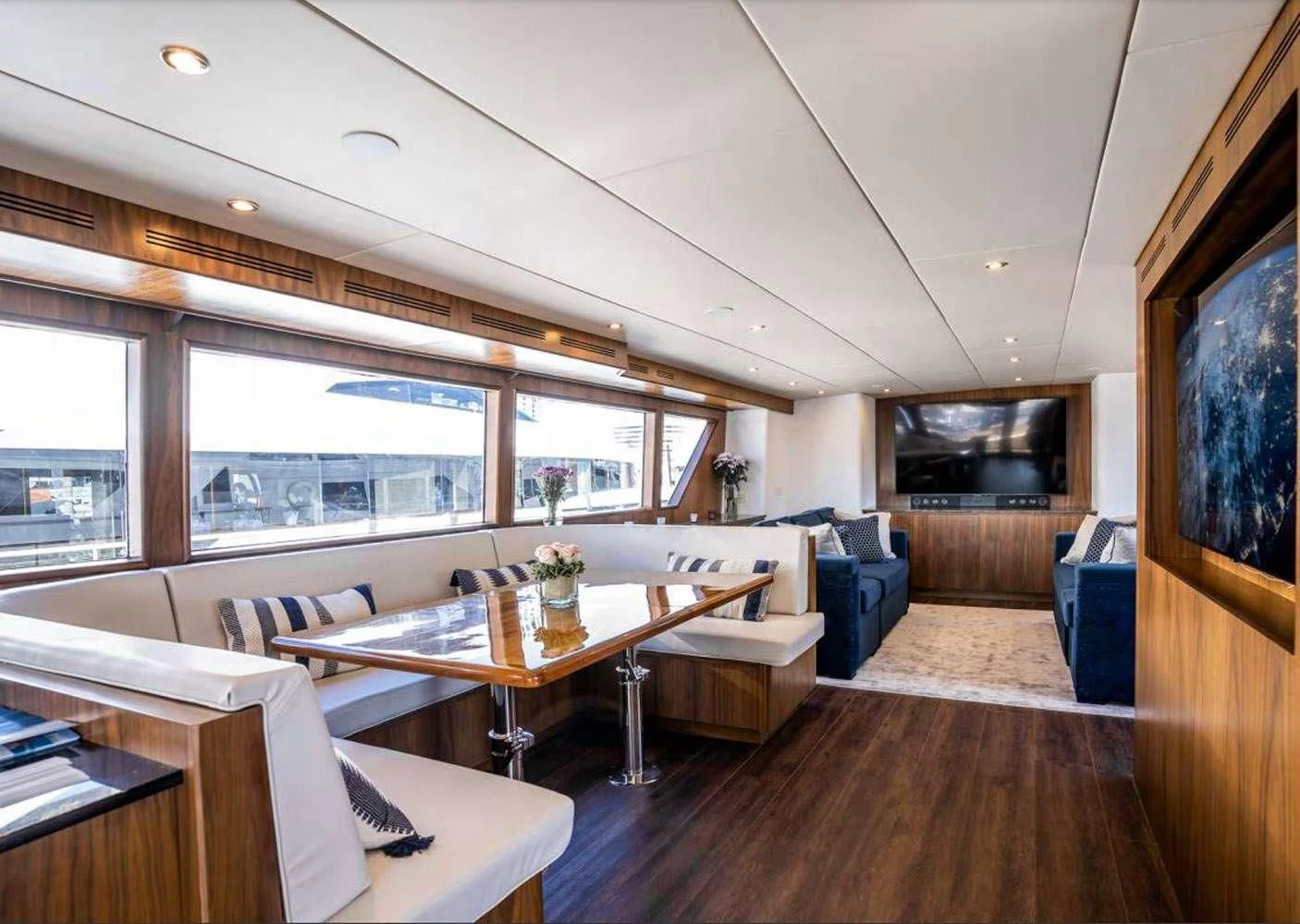 a living room with a table and chairs aboard A PLACE IN THE SUN Yacht for Sale