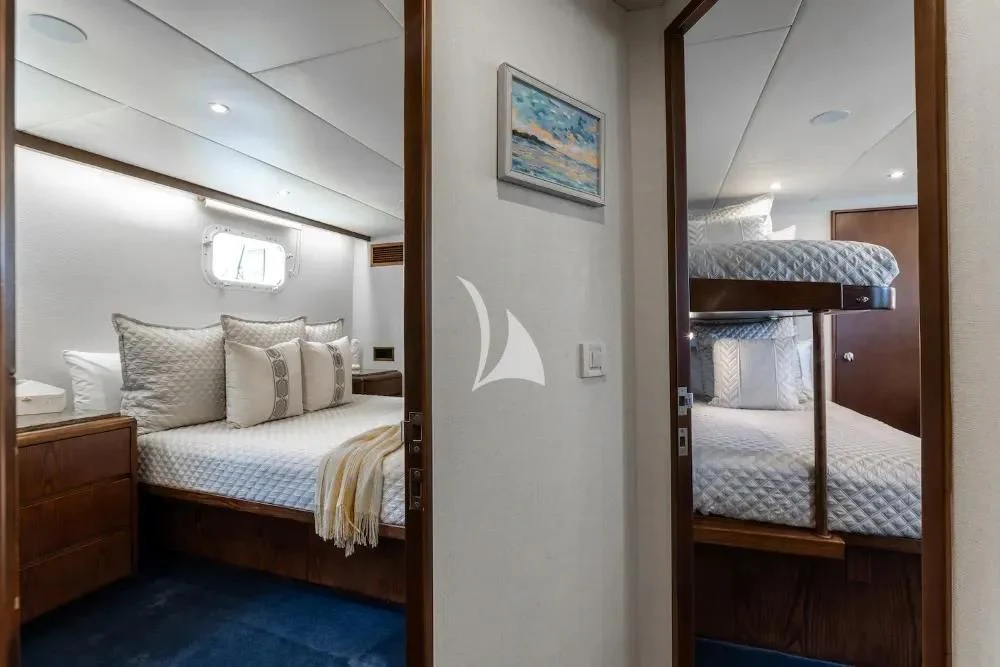 a room with two beds aboard A PLACE IN THE SUN Yacht for Sale
