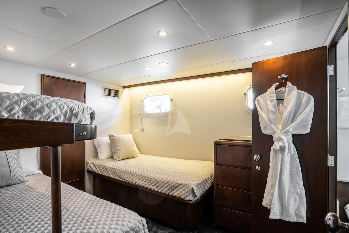 a room with a bed and a mirror aboard A PLACE IN THE SUN Yacht for Sale