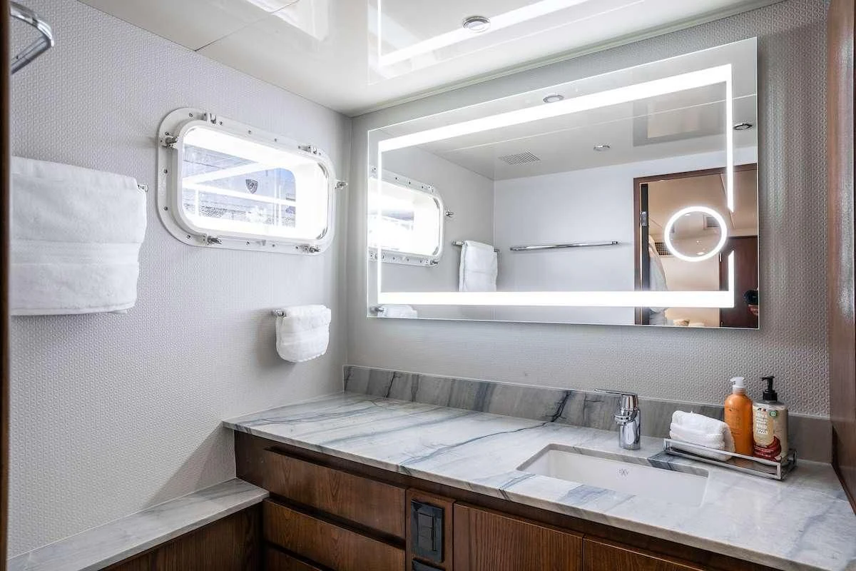 a bathroom with a sink and a mirror aboard A PLACE IN THE SUN Yacht for Sale