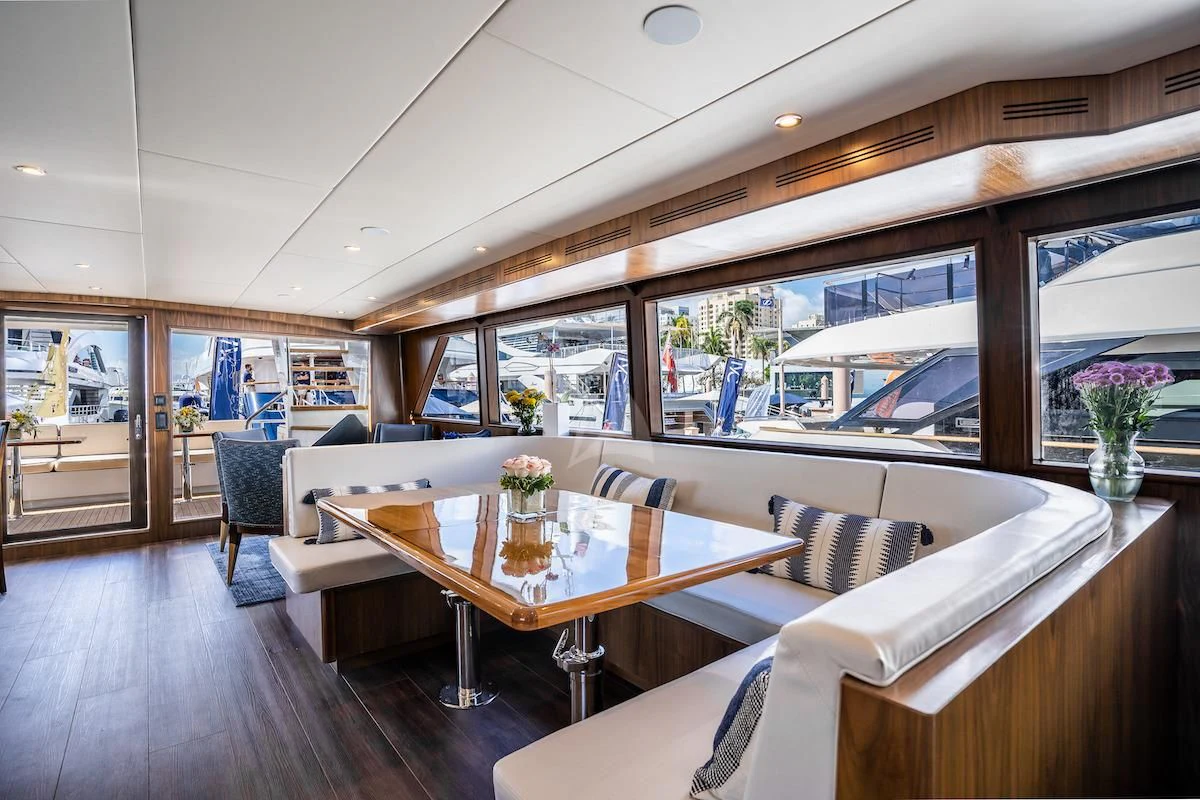 a living room with a large window aboard A PLACE IN THE SUN Yacht for Sale
