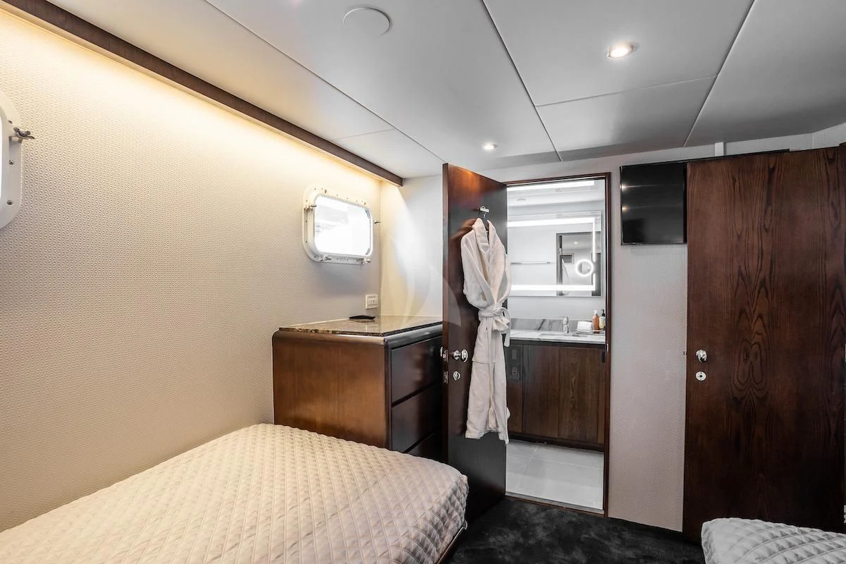 a hotel room with a bed and a mirror aboard A PLACE IN THE SUN Yacht for Sale