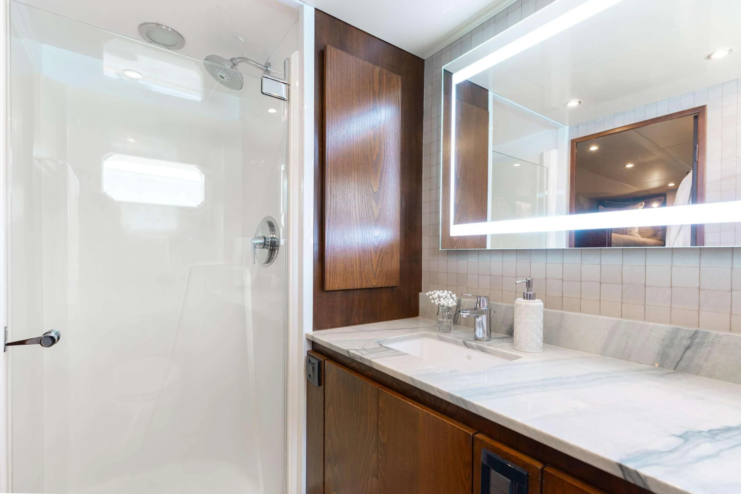 a bathroom with a large mirror aboard A PLACE IN THE SUN Yacht for Sale