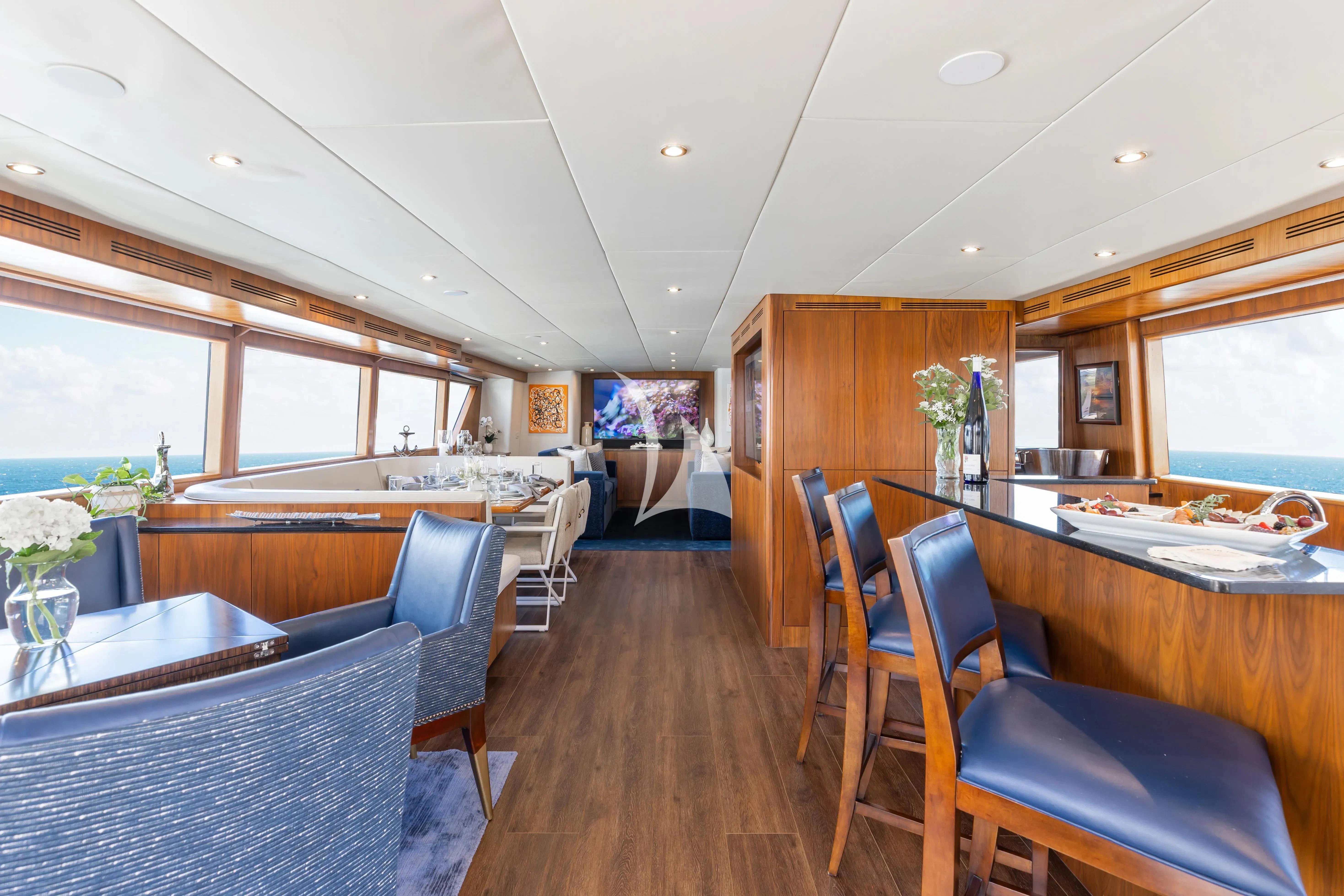 a large kitchen with a bar and seating area aboard A PLACE IN THE SUN Yacht for Sale