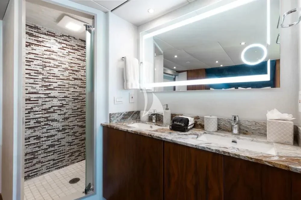 a bathroom with a sink and a large mirror aboard A PLACE IN THE SUN Yacht for Sale