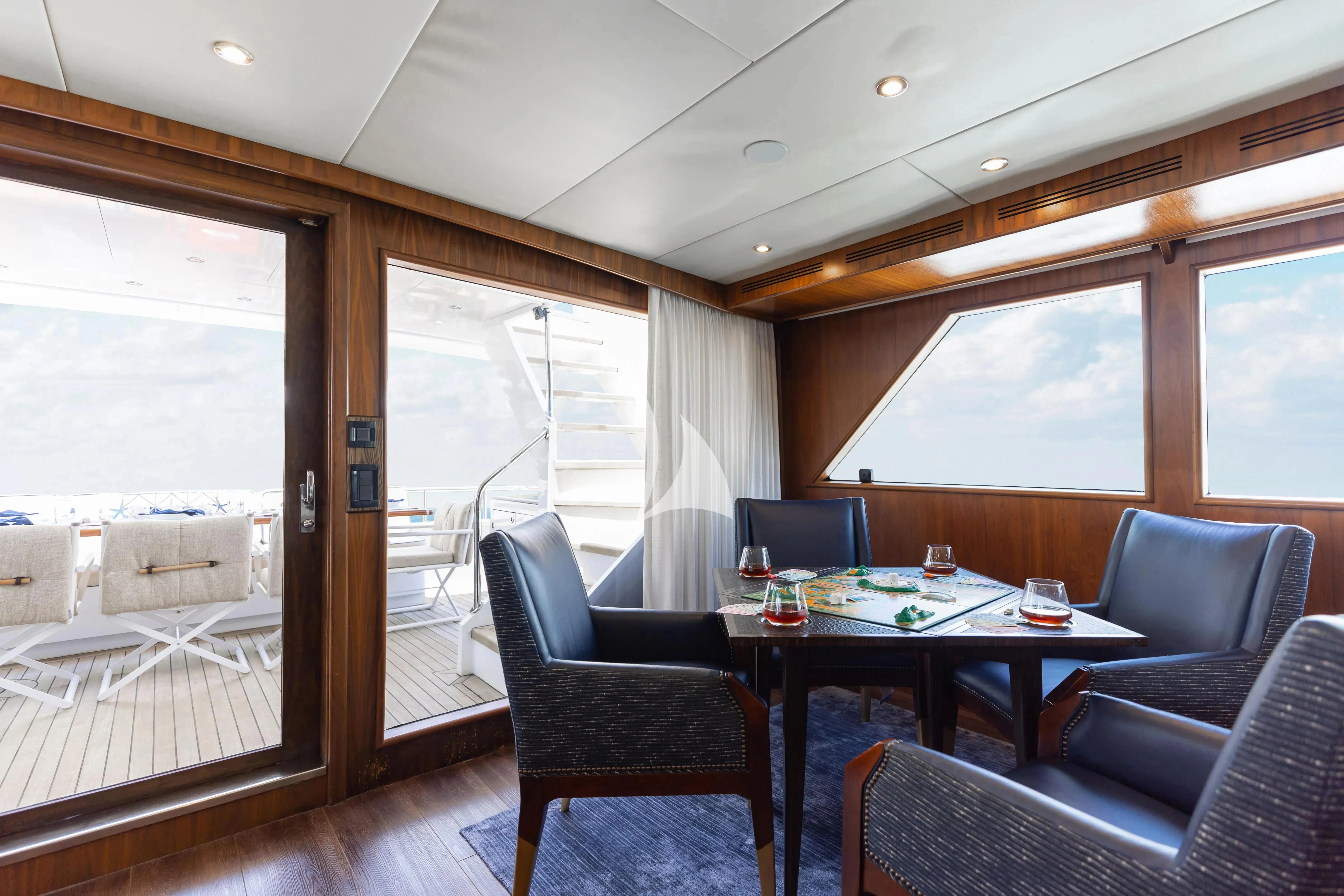 a room with a table and chairs aboard A PLACE IN THE SUN Yacht for Sale