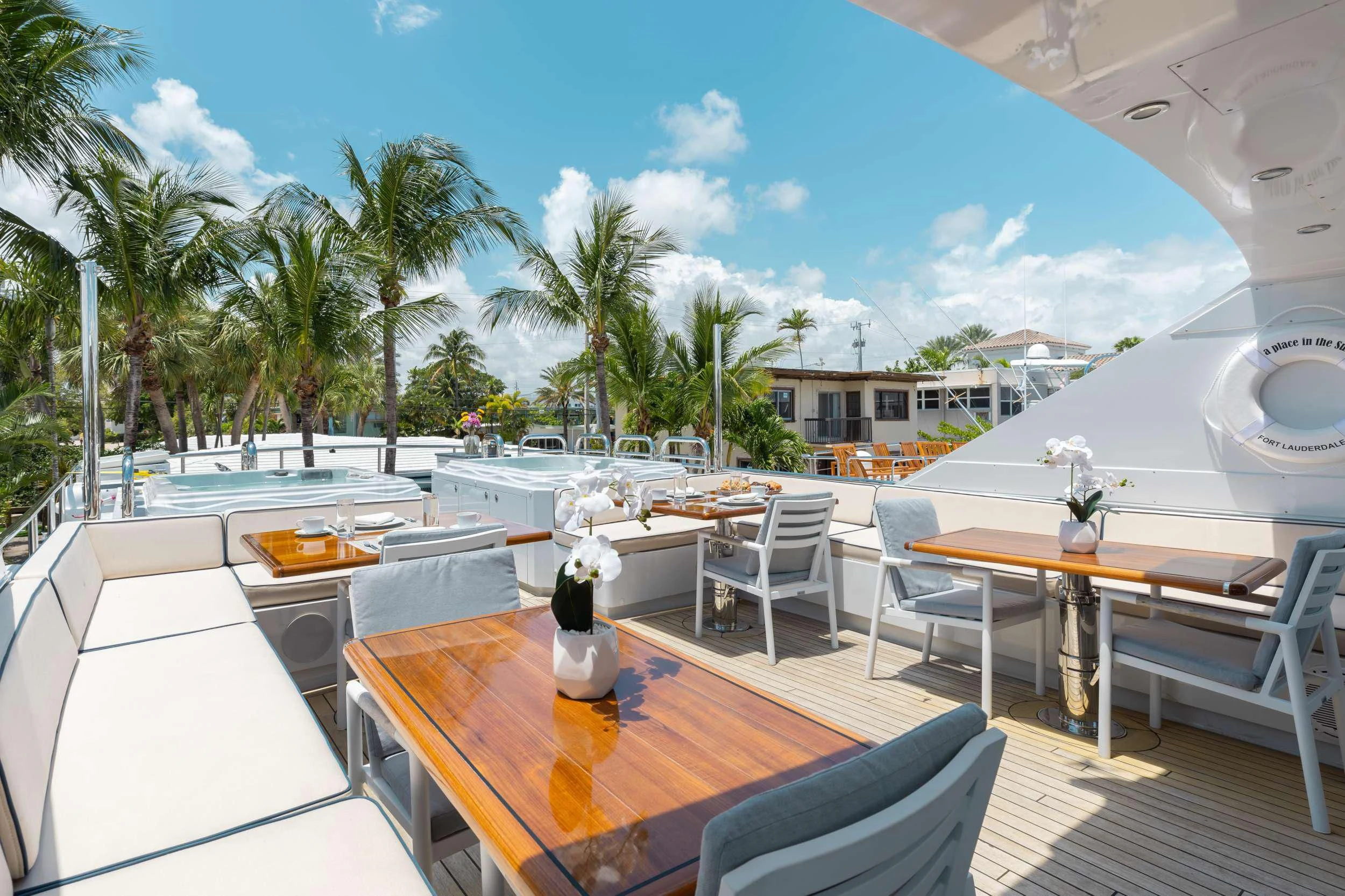 a table and chairs on a patio aboard A PLACE IN THE SUN Yacht for Sale