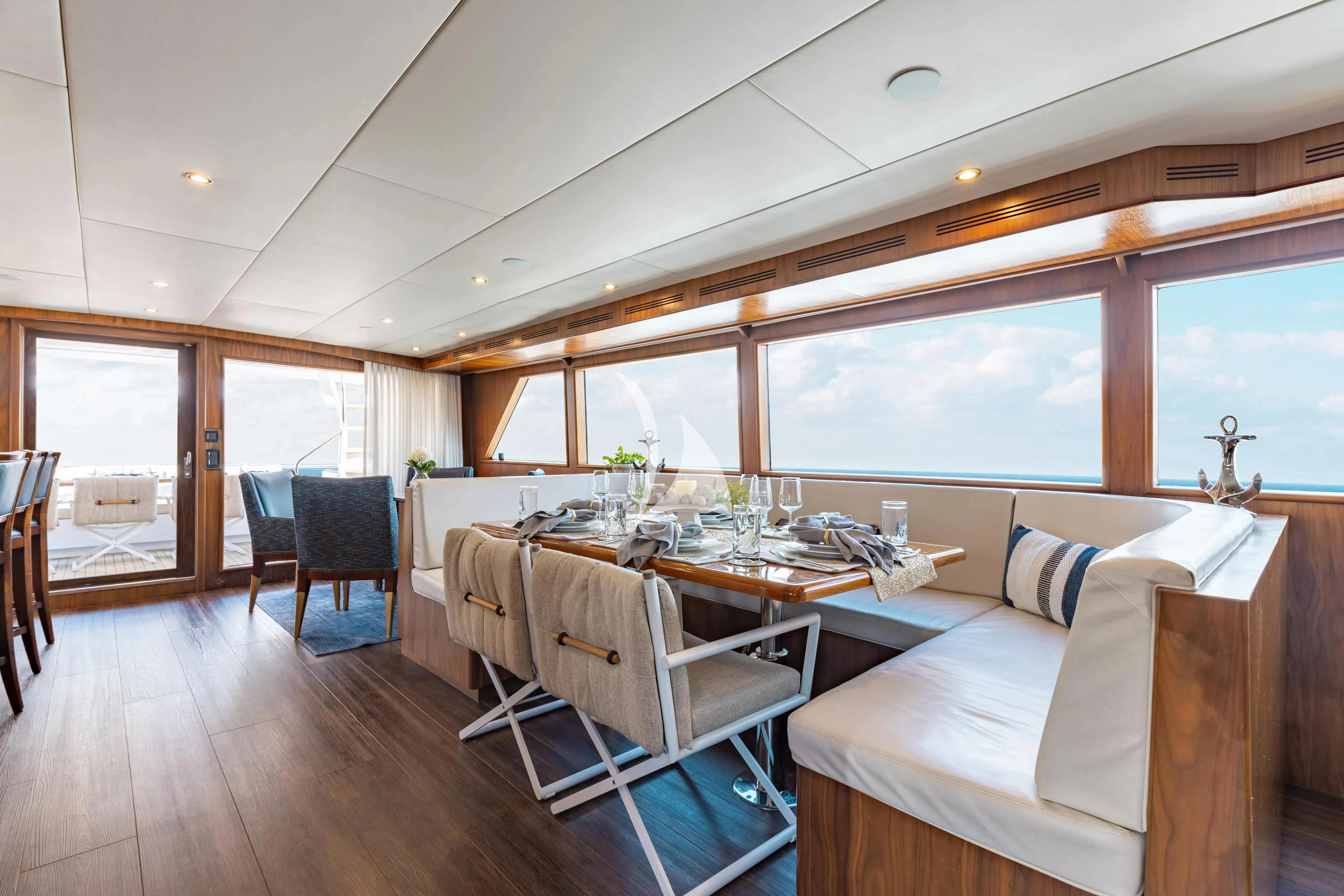 a large dining room with a large table and chairs aboard A PLACE IN THE SUN Yacht for Sale