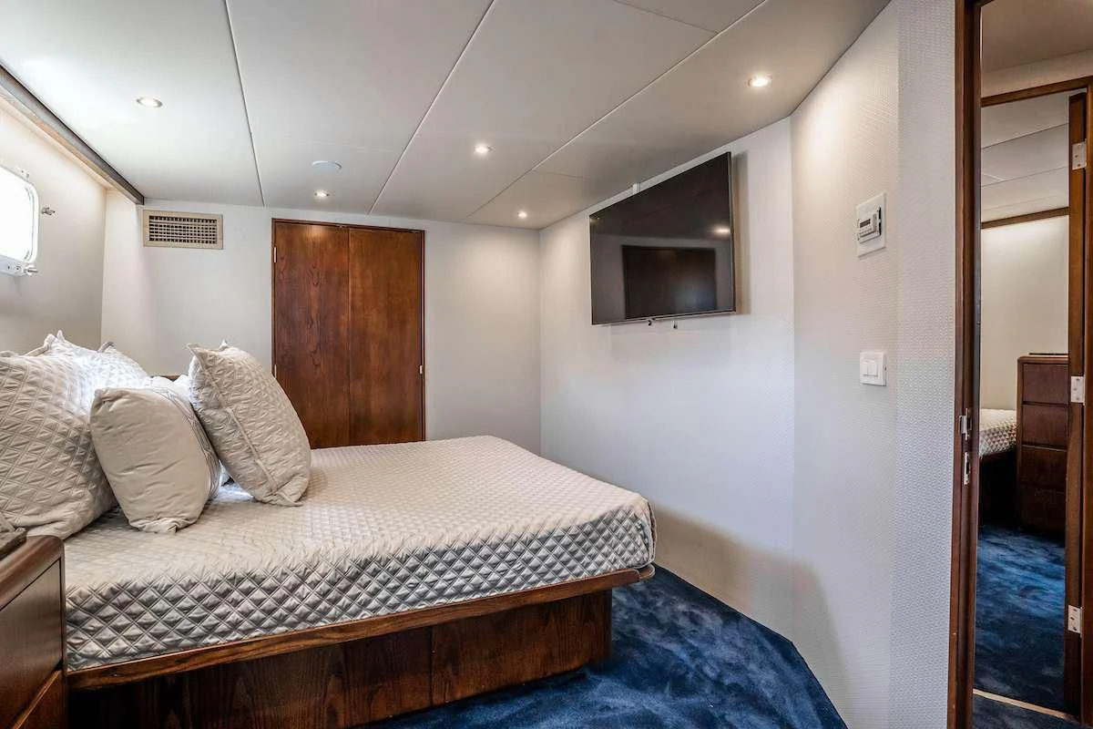 a bed in a room aboard A PLACE IN THE SUN Yacht for Sale