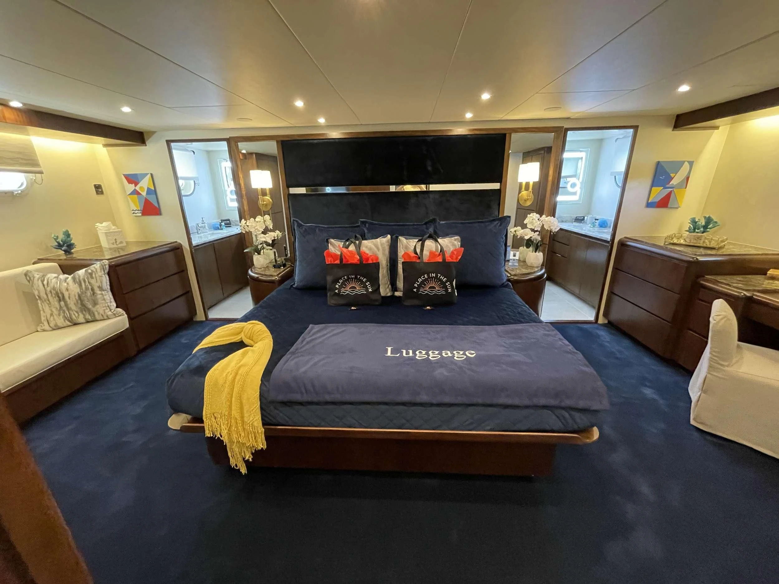 a bedroom with a bed and a blue bed aboard A PLACE IN THE SUN Yacht for Sale