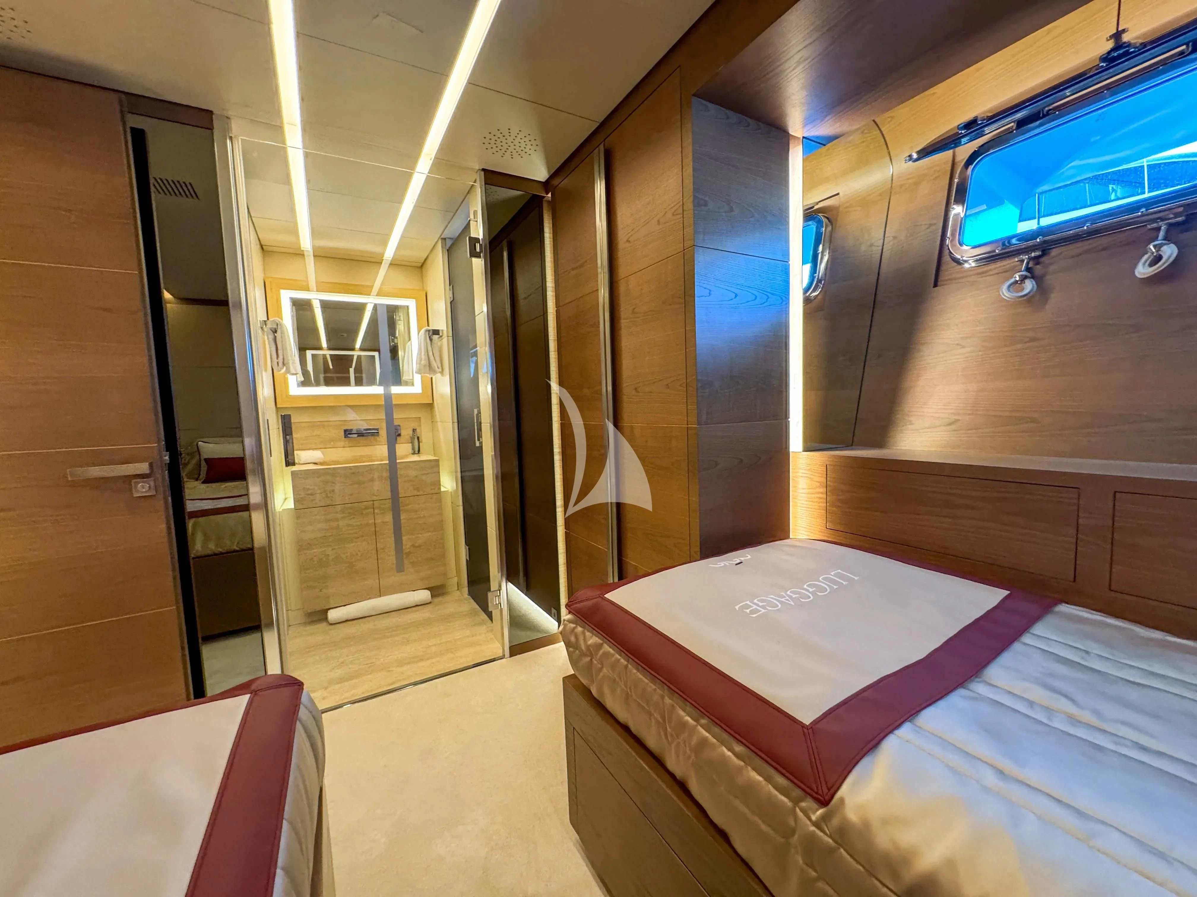 a room with a bed and a window aboard NAIA Yacht for Sale