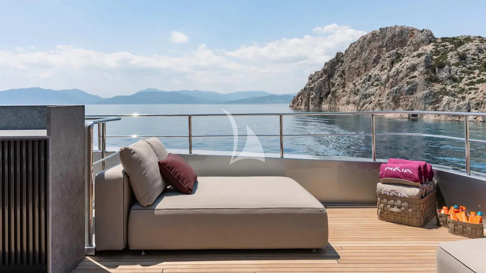 a bed on a balcony overlooking a body of water aboard NAIA Yacht for Sale