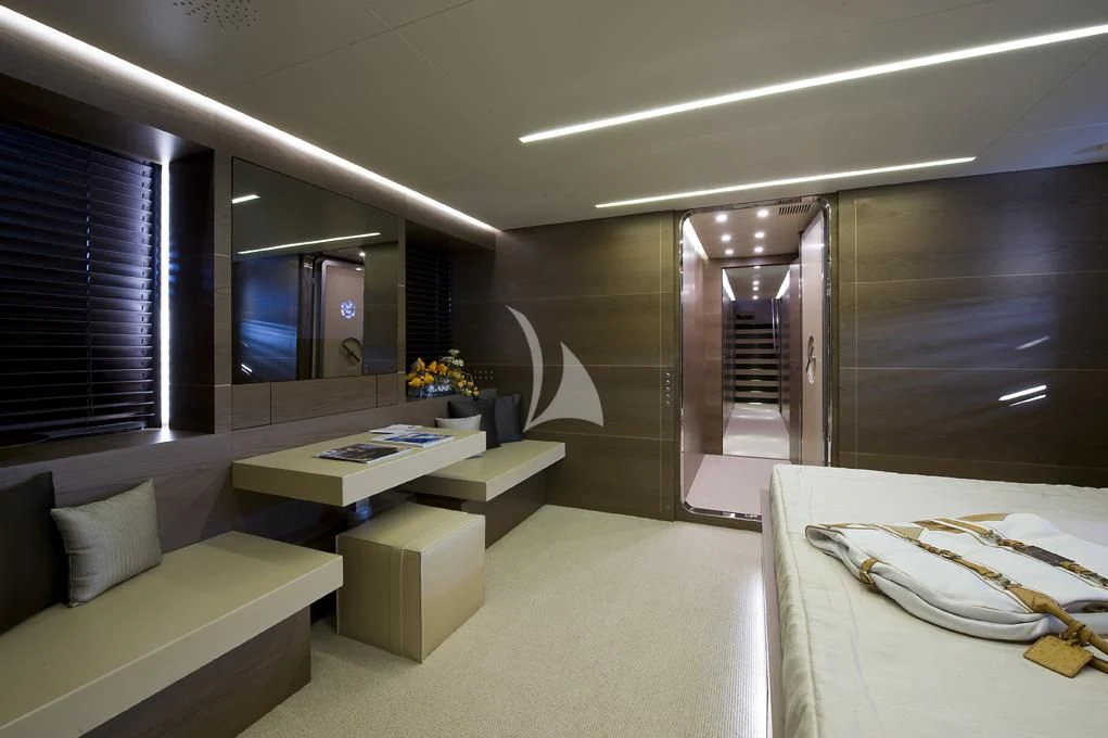 a room with a bed and a tv aboard NAIA Yacht for Sale