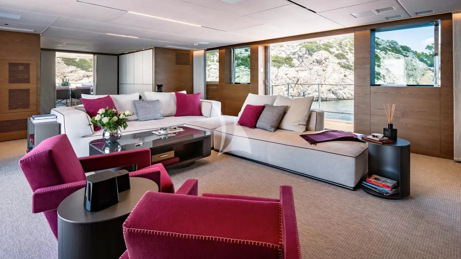 a living room with a couch and a table aboard NAIA Yacht for Sale