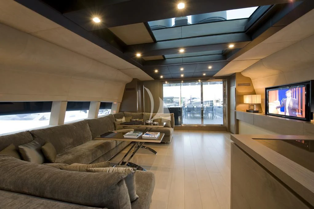 a living room with a large screen aboard NAIA Yacht for Sale