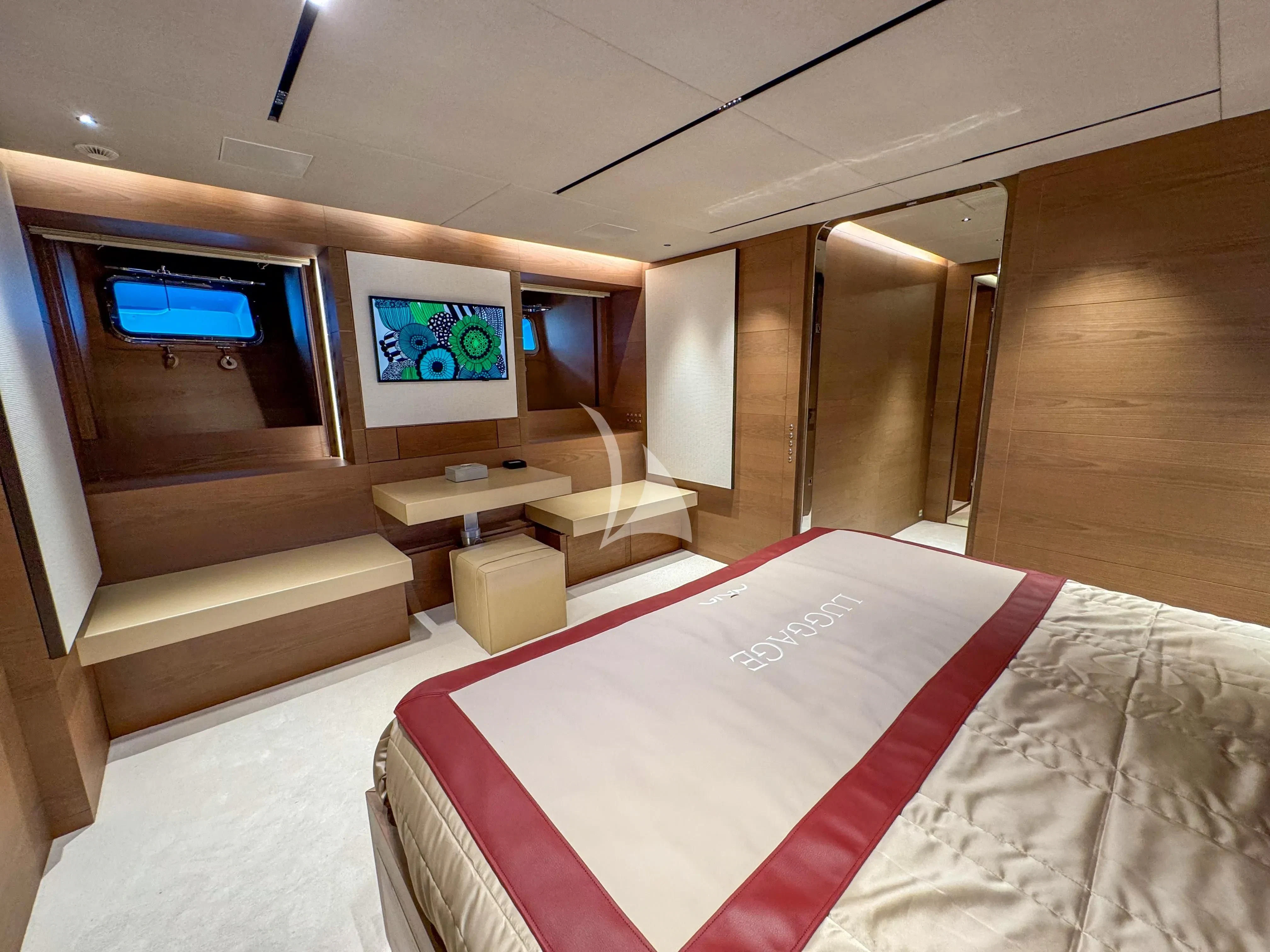 a room with a bed and a tv on the wall aboard NAIA Yacht for Sale