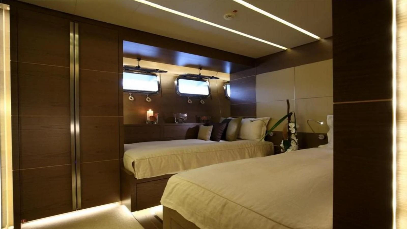a room with a bed and a guitar aboard NAIA Yacht for Sale